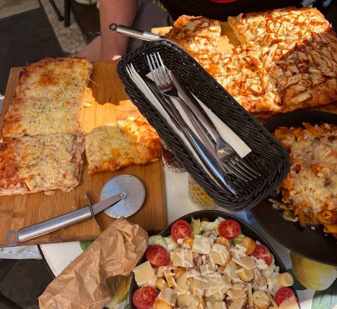 Pizza slices and a fresh salad bowl